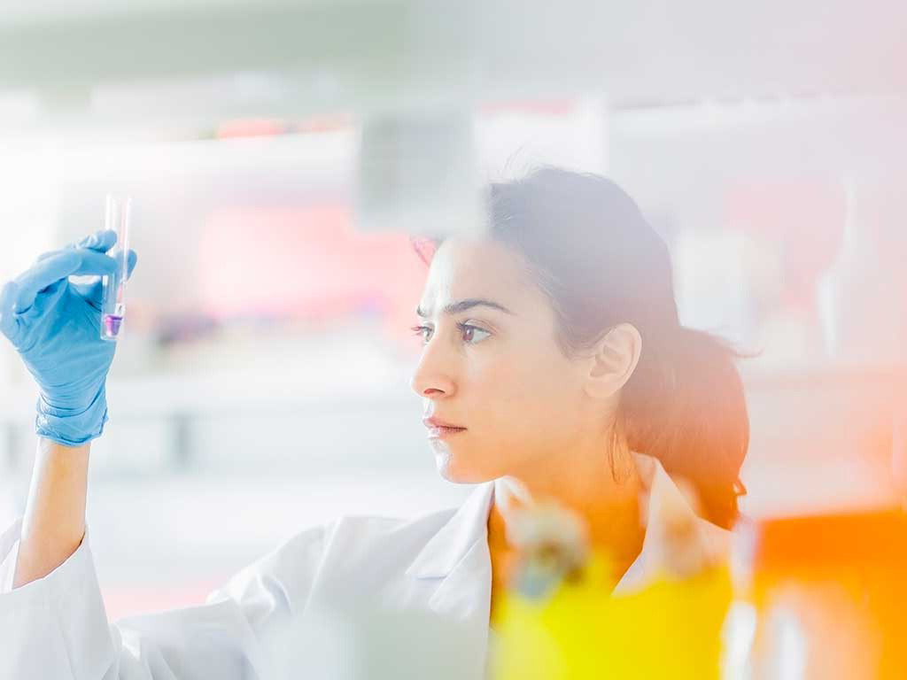 Scientist in a lab holding a vial
